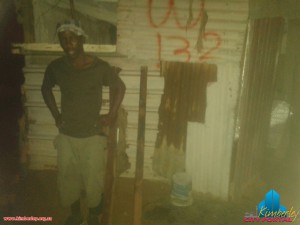 Tebogo in front his shack